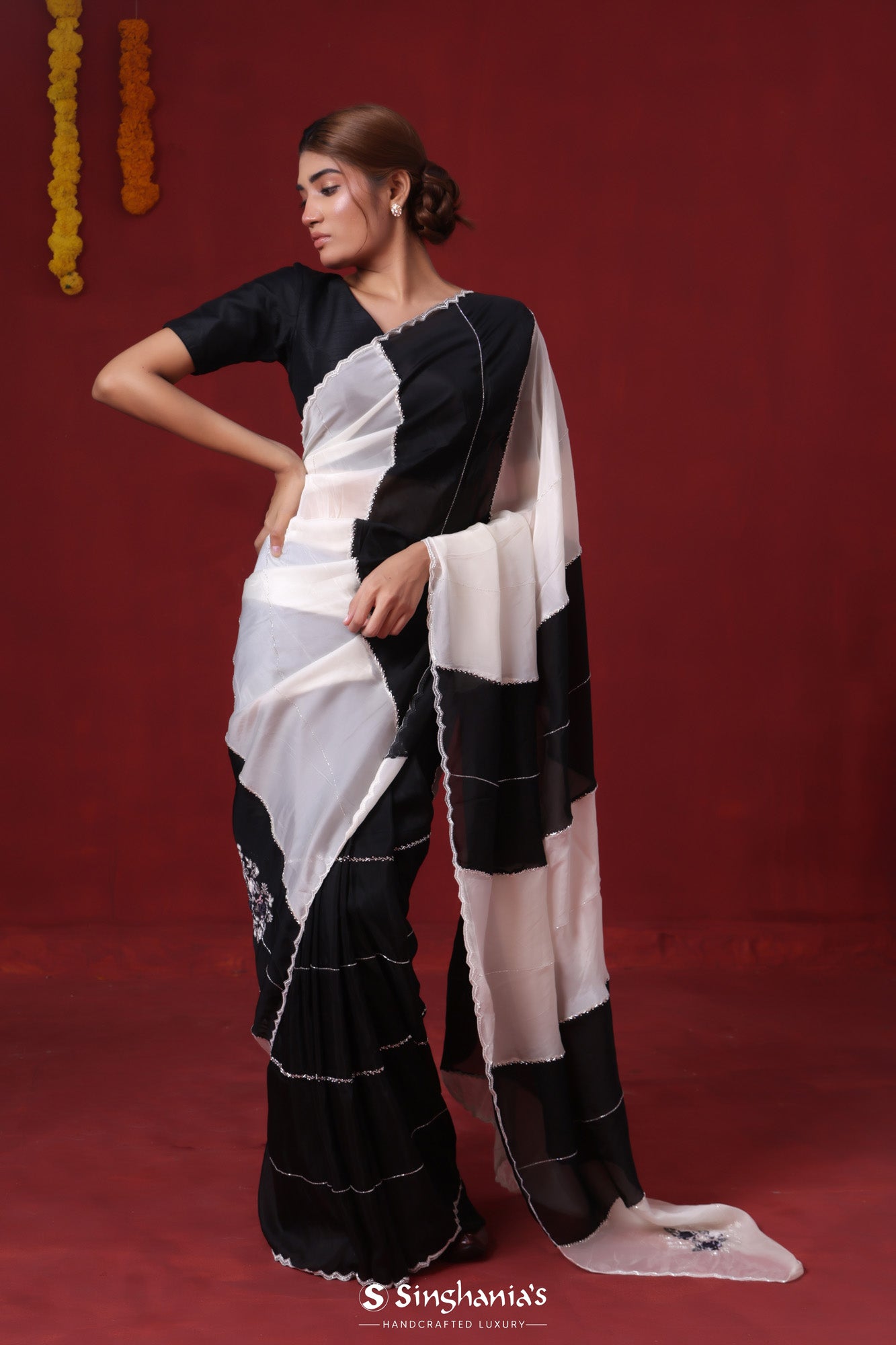 Truly Divine - Black saree modeled by a supermodel - SAR1205 Off white,  green and black designer saree modelled by a super model. Elegant white and  green combination saree with black embroidered